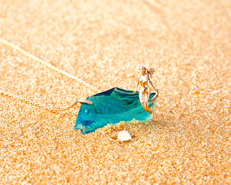 For many the Awakening story starts with remembering Lemuria, its mermaid, dolphins ....  14k Mermaid sitting atop an electric blue Andara, on an 18K gold necklace with diamonds holders.