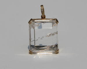 Enhydro quartz extremely clear with 6 water bubbles.  14 k yellow gold with diamonds on each corner.  Enhydro quartz creates a link between Heaven and Earth.