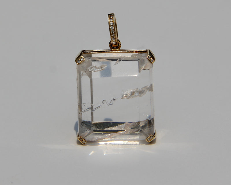 Enhydro quartz extremely clear with 6 water bubbles.  14 k yellow gold with diamonds on each corner.  Enhydro quartz creates a link between Heaven and Earth.