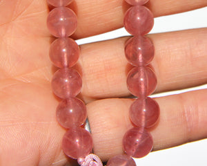 Madagascar "Jelly" Rose quartz with chatoyance and stars.  The Madagascar rose quartz is an embodiment of the Love frequency, Divine Love.  The "Jelly" Rose quartz, may look brownish at night, its real beauty shine against the skin. The color is very different from the normal pale rose quartz. (You have to be prepared to be surprised by it, if you received it at night). It is truly a magnificent and rare mineral specimen.  Madagascar "Jelly" starRose quartz beads, in the middle one 18k gold beads with hot p