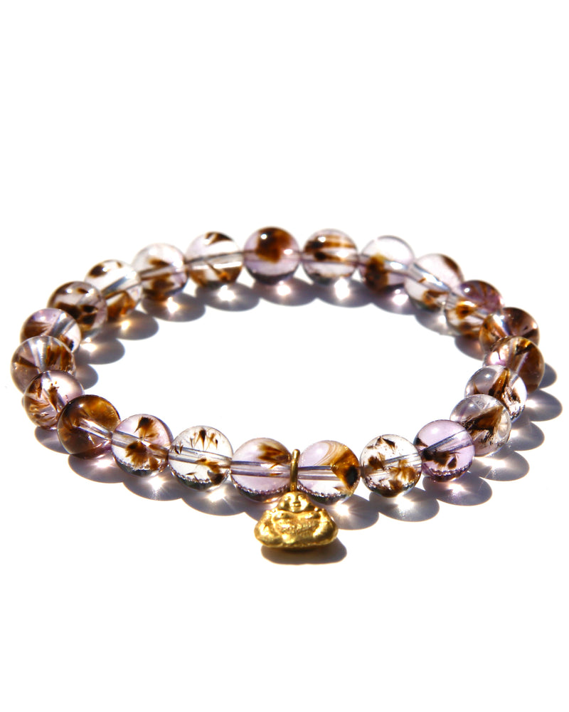 Stretch bracelet, beads made of Cacoxenite Amethyst.   Each beads has wisps of golden cacoxenite. The beads are crystal clear and full of Light. This is truly a magnificent strandSmall 18k gold laughing Buddha.