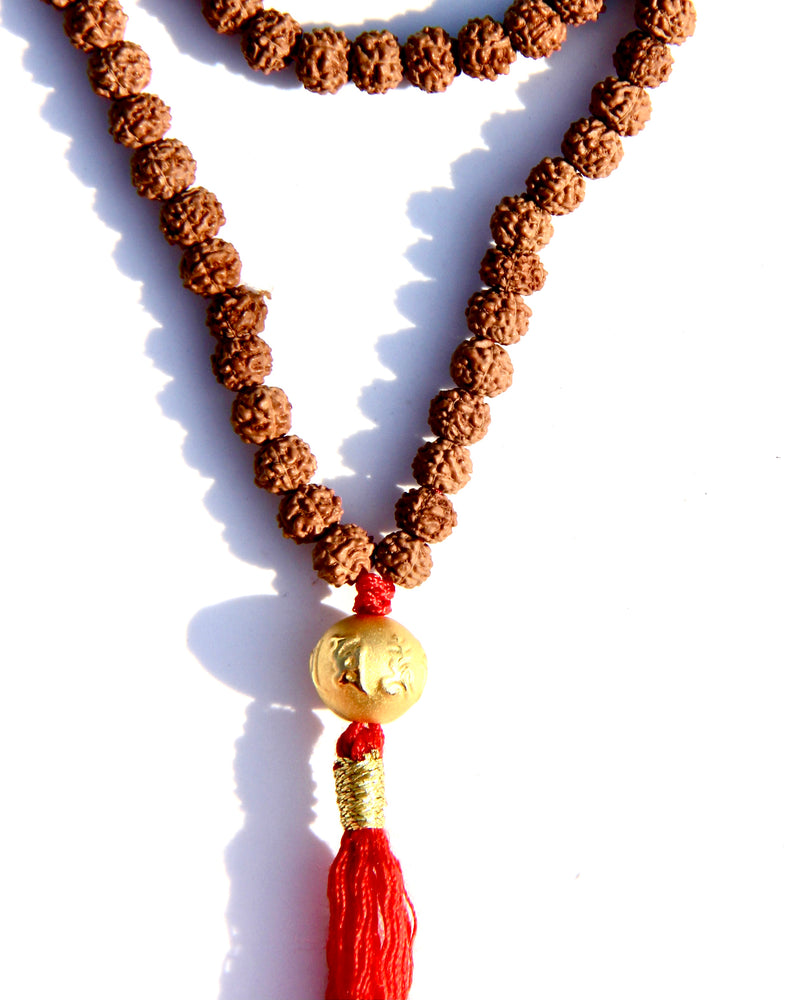 Rudraksha beads mala necklace with a 24k gold bead.  It is written on the gold bead: Om Mani Padme Om.  This is stage 2 of Rudhraksha beads ' growth. The Rudraksha beads in the minis collection are smoother and the clear separation lines have not appeared yet..  It is said that wearing a Rudraksha beads mala cancels your karma!