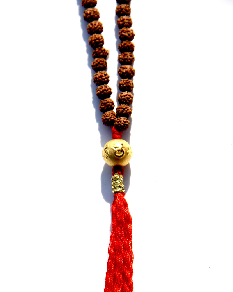 Rudraksha beads mala necklace with a 24k gold bead.  It is written on the gold bead: Om Mani Padme Om.  This is stage 2 of Rudhraksha beads ' growth. The Rudraksha beads in the minis collection are smoother and the clear separation lines have not appeared yet..  It is said that wearing a Rudraksha beads mala cancels your karma!