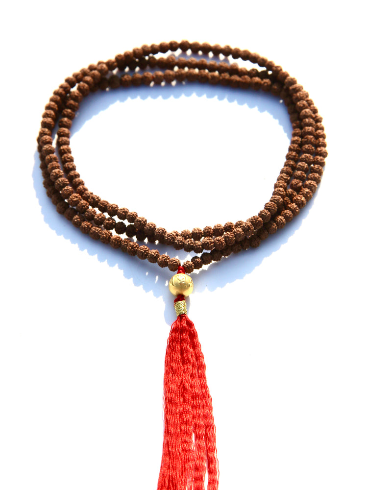 Rudraksha beads mala necklace with a 24k gold bead.  It is written on the gold bead: Om Mani Padme Om.  This is stage 2 of Rudhraksha beads ' growth. The Rudraksha beads in the minis collection are smoother and the clear separation lines have not appeared yet..  It is said that wearing a Rudraksha beads mala cancels your karma!