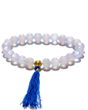 The Healers bracelet, blue chalcedony.  With a 24k gold bead and blue cotton tassel.  Blue chalcedony helps create the Sacred voice. It also has strong color healing abilities.  Stretch bracelet. Length: 18 cms.