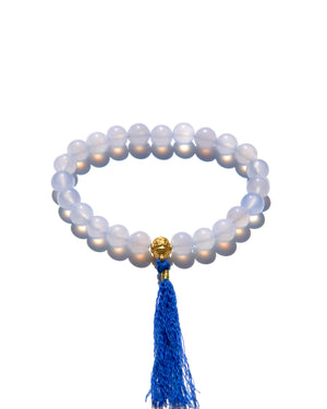 The Healers bracelet, blue chalcedony.  With a 24k gold bead and blue cotton tassel.  Blue chalcedony helps create the Sacred voice. It also has strong color healing abilities.  Stretch bracelet. Length: 18 cms.