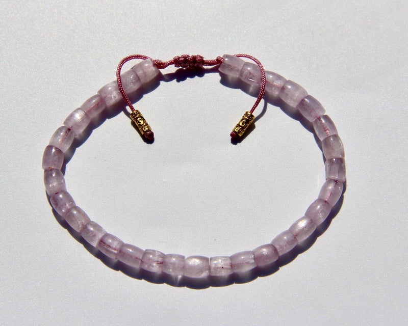 The Healer's bracelet , Kunzite mini.  Small kunzite beads with two 24K gold beads, with circles pattern (symbols of the Core , the center of the Higher Heart) drawn on them.