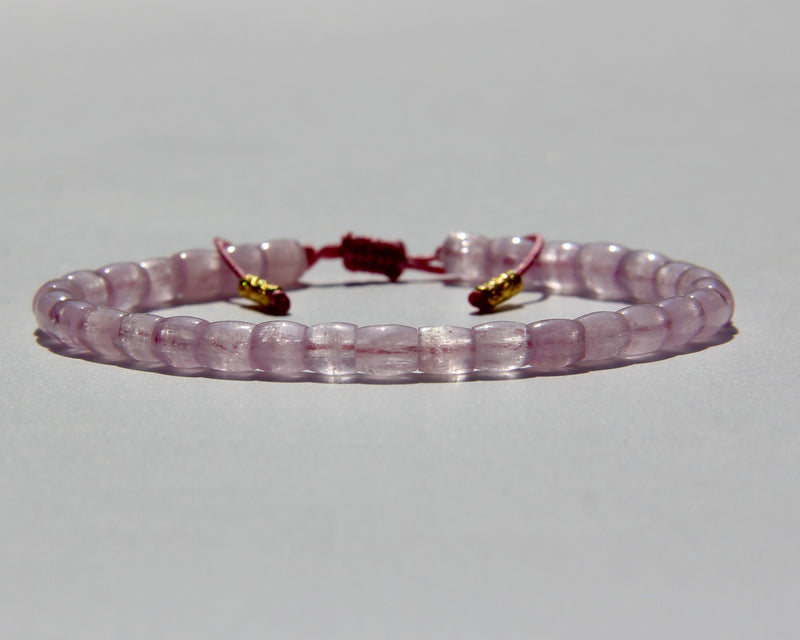 The Healer's bracelet , Kunzite mini.  Small kunzite beads with two 24K gold beads, with circles pattern (symbols of the Core , the center of the Higher Heart) drawn on them.