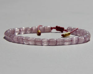 The Healer's bracelet , Kunzite mini.  Small kunzite beads with two 24K gold beads, with circles pattern (symbols of the Core , the center of the Higher Heart) drawn on them.