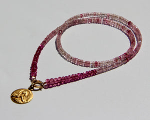 Pink tourmaline and rubellite necklace with an 18k yellow gold and white diamond clicker that can be opened to add more pendants. On the clicker an 18k yellow gold medal of the Divine feminine. Tourmaline and rubellite are stone vibrating at Divine Love frequency.  The necklace will rest on the higher Heart chakra.