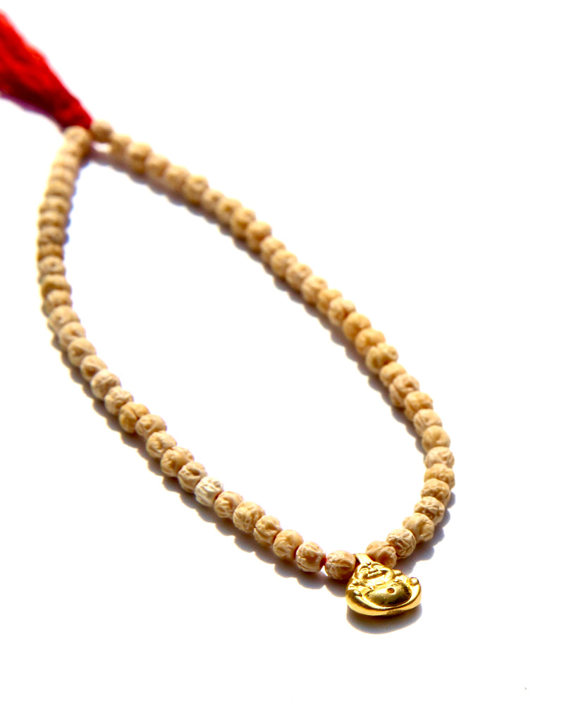 The Minis, a collection of tiny bracelets exploring the Universe of symbolism, made of Rudraksha beads strung on red thread, gold beads ....   This bracelet is made of Rudraksha beads with a 24k small laughing buddha.  Buddha size: 8mm