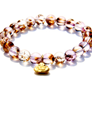 Stretch bracelet, beads made of Cacoxenite Amethyst.   Each beads has wisps of golden cacoxenite. The beads are crystal clear and full of Light. This is truly a magnificent strandSmall 18k gold laughing Buddha.