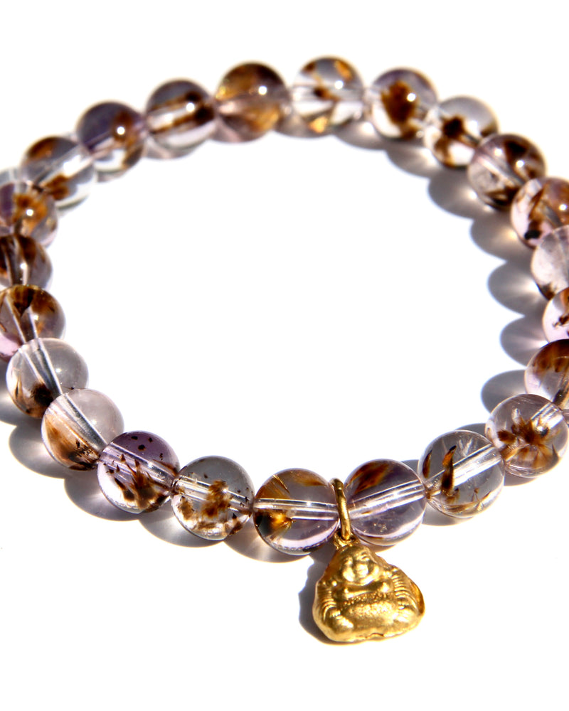 Stretch bracelet, beads made of Cacoxenite Amethyst.   Each beads has wisps of golden cacoxenite. The beads are crystal clear and full of Light. This is truly a magnificent strandSmall 18k gold laughing Buddha.