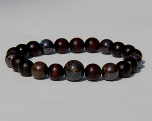 The Healer's bracelet with Sandalwood beads and 7 matrix opal beads.  Each of the beds are pure sandalwood, and can be crushed and burned as pure incense.  The heat of your skin will develop the aroma of Sandalwood.