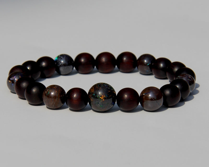 The Healer's bracelet with Sandalwood beads and 7 matrix opal beads.  Each of the beds are pure sandalwood, and can be crushed and burned as pure incense.  The heat of your skin will develop the aroma of Sandalwood.